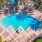 a swimming pool surrounded by palm trees
