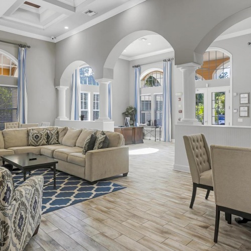 Settle into comfort at Courtney Isles leasing office with a large chandelier and a large dining table