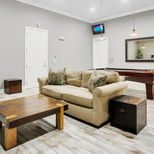 Settle into comfort at Courtney Isles a living room with a couch and a table
