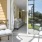 a  patio with a glass door and a chair