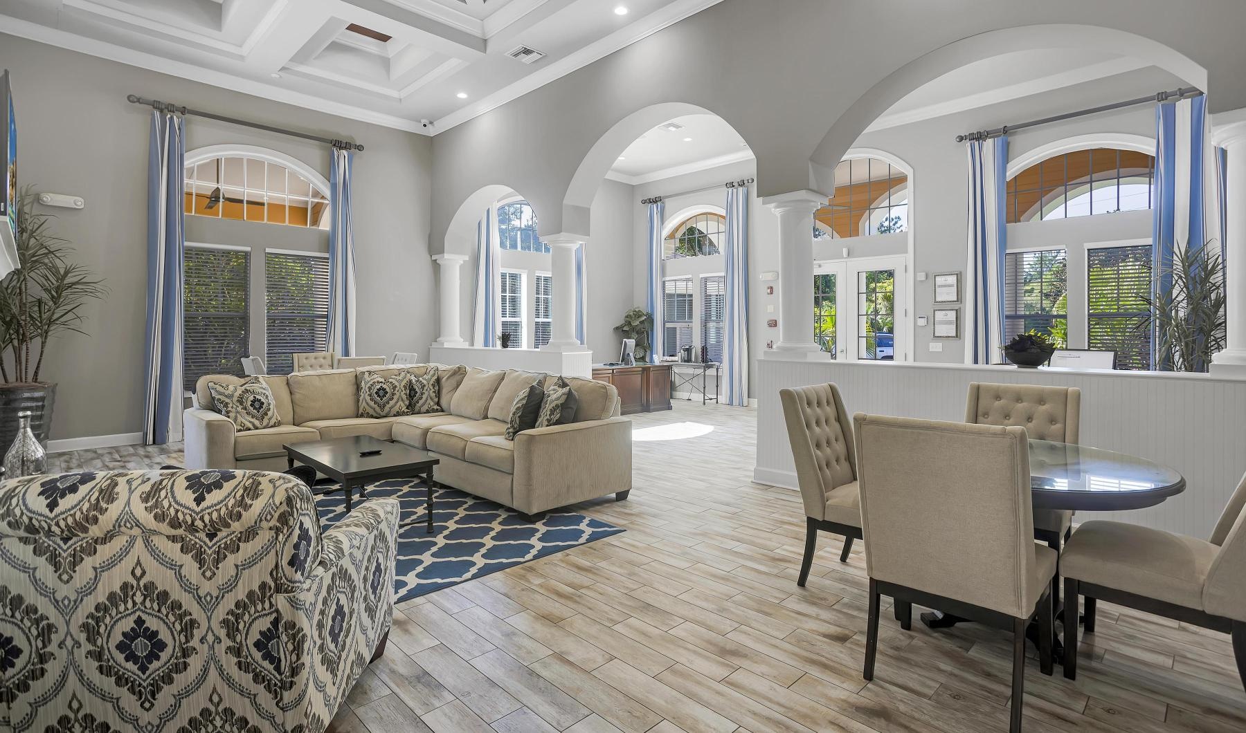 Settle into comfort at Courtney Isles leasing office with a large chandelier and a large dining table