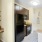 a kitchen with a black refrigerator